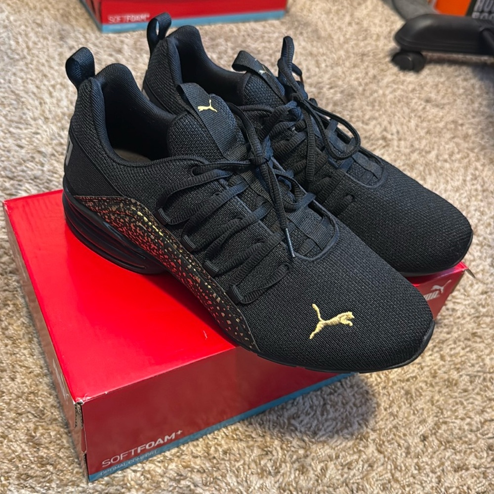 Black and gold, tennis shoes, puma brand size 11 brand new in box!
